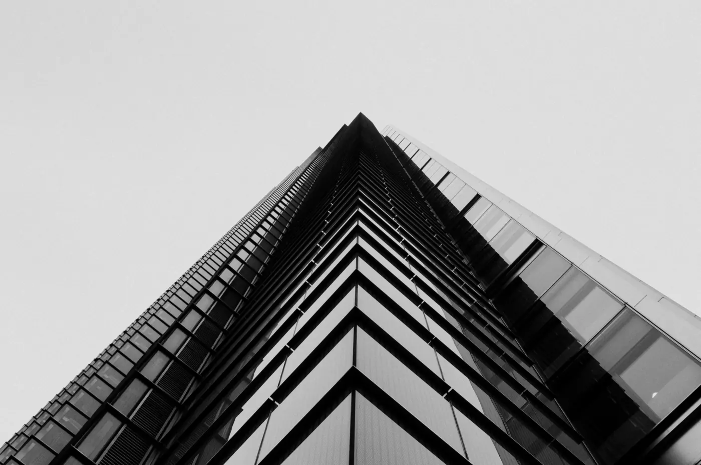 Looking up at a concrete and glass tower in London